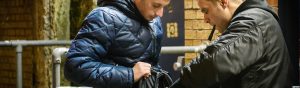 close circuit retail security checking a man's bag